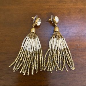 Tassel gold and white earrings with a gem on the front post.